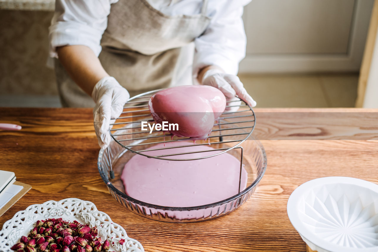 Mousse cake. mirror glaze cake. process of making heart shape mousse cake with pink mirror glaze