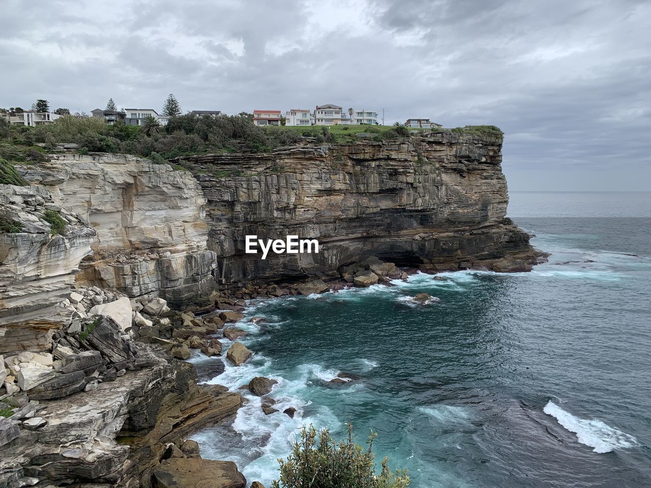 Rock formations by sea against sky