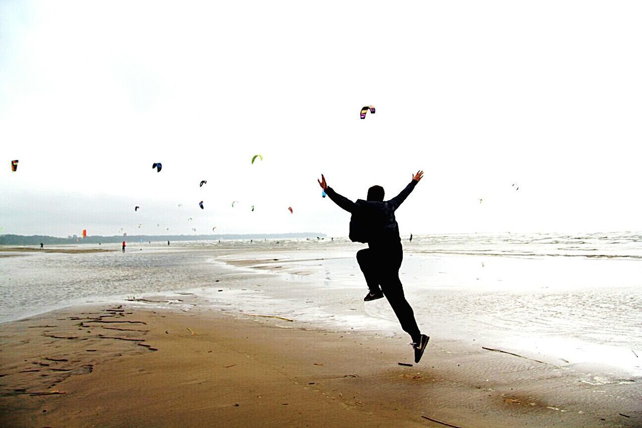 WOMAN JUMPING ON BEACH