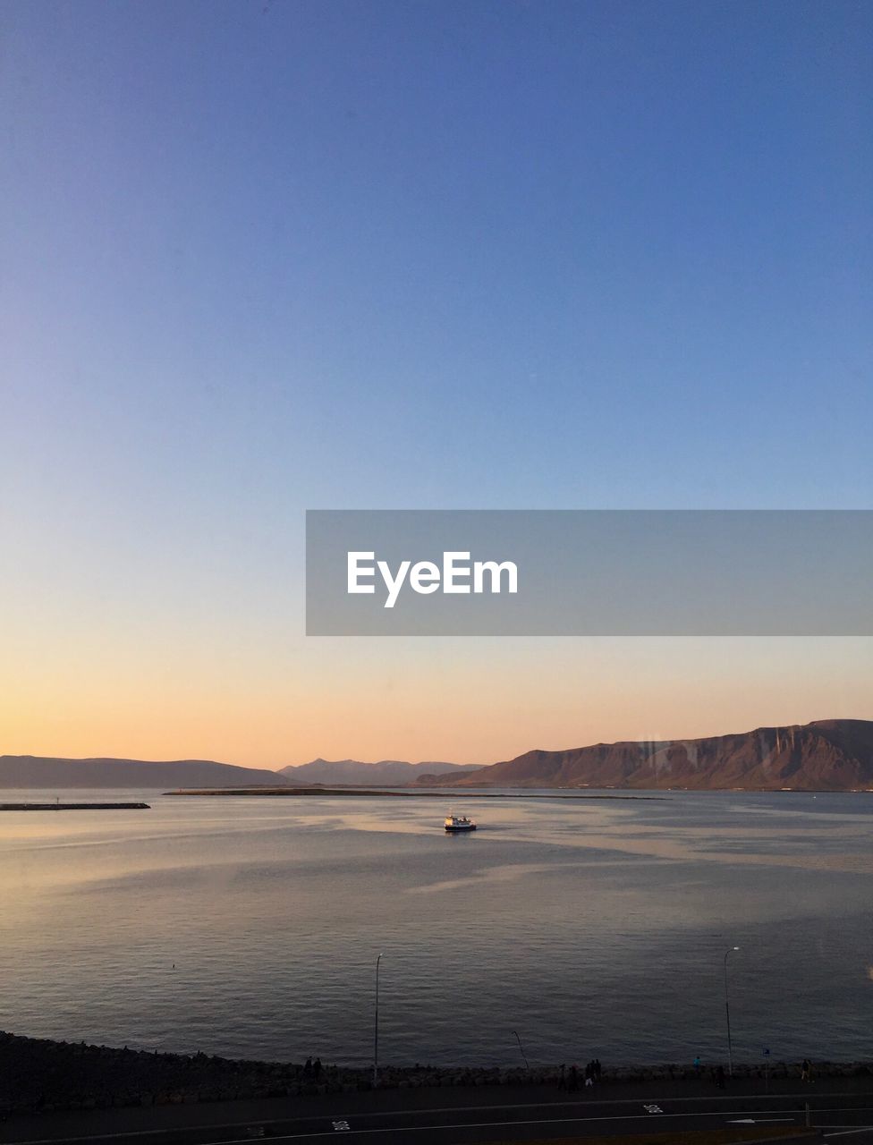 Scenic view of sea against clear sky at sunset