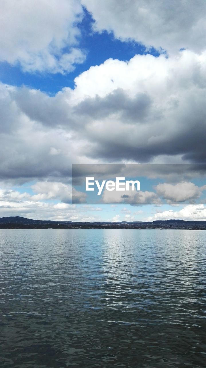 VIEW OF SEA AGAINST CLOUDY SKY