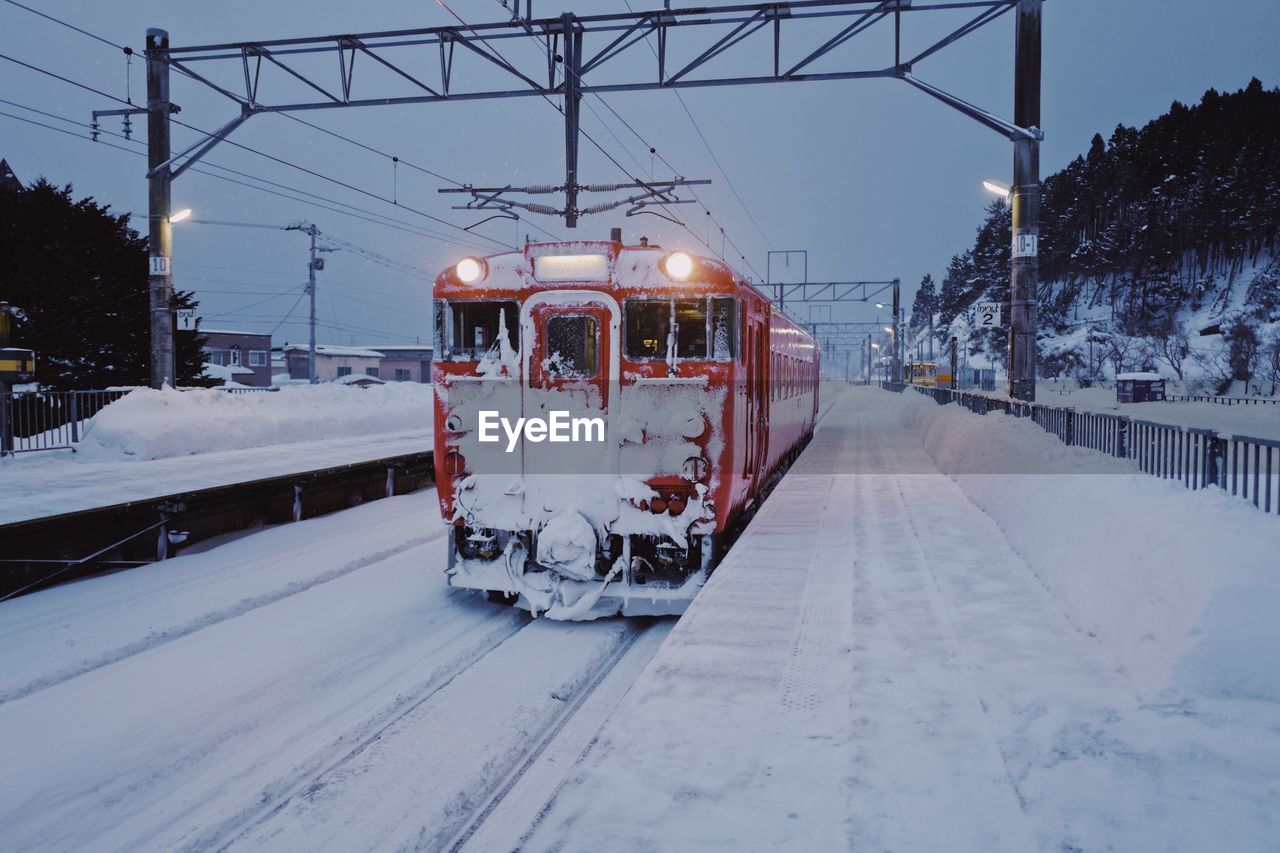 Train on railroad station platform during winter