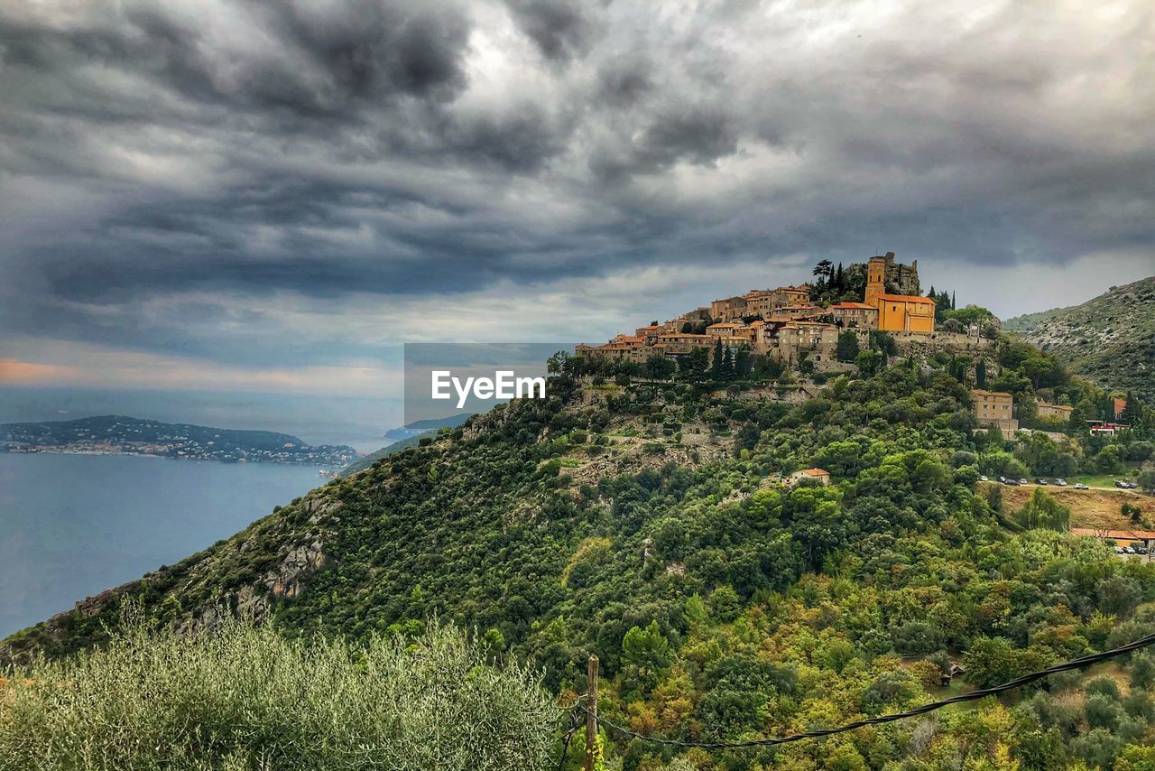 View of castle on mountain against cloudy sky