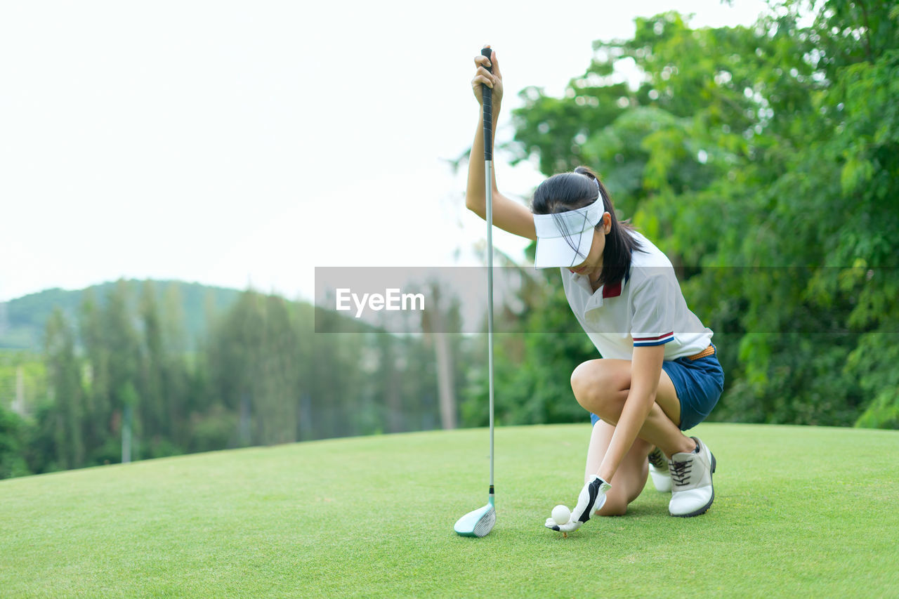 Woman playing golf in park