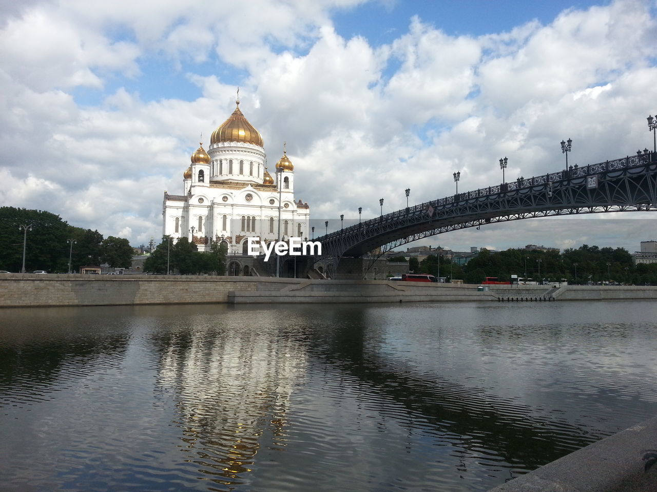 Patriarshy bridge over moskva river by cathedral of christ the saviour against sky