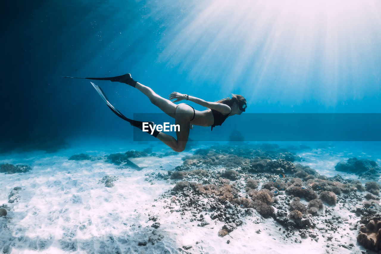 low angle view of woman swimming in sea