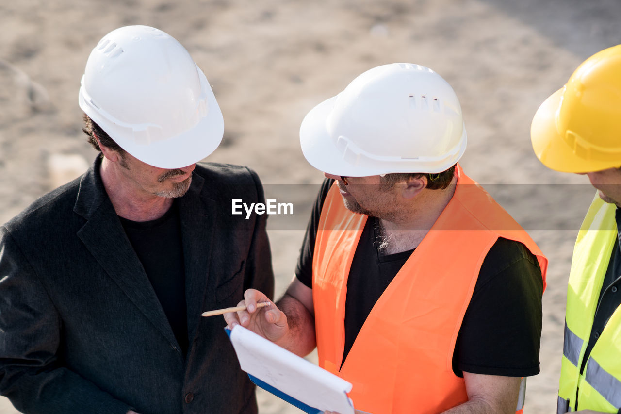 Engineers discussing at construction site