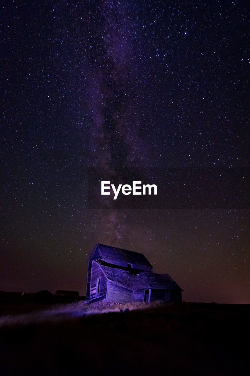 BUILDING AGAINST SKY AT NIGHT