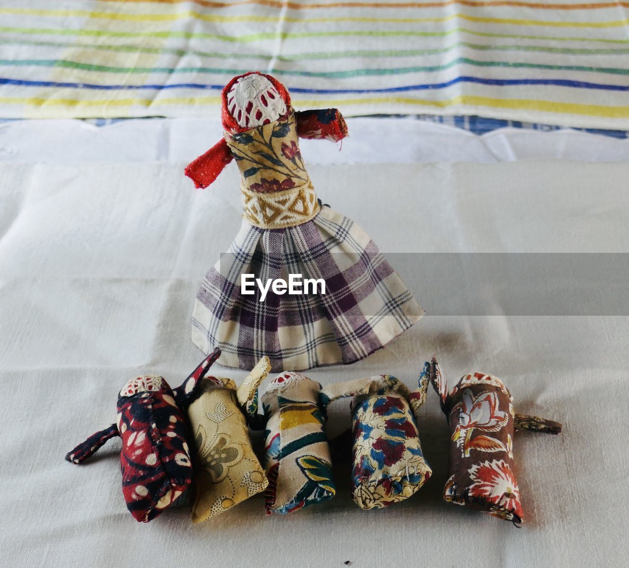 HIGH ANGLE VIEW OF WOMAN SITTING ON BED WITH TOY