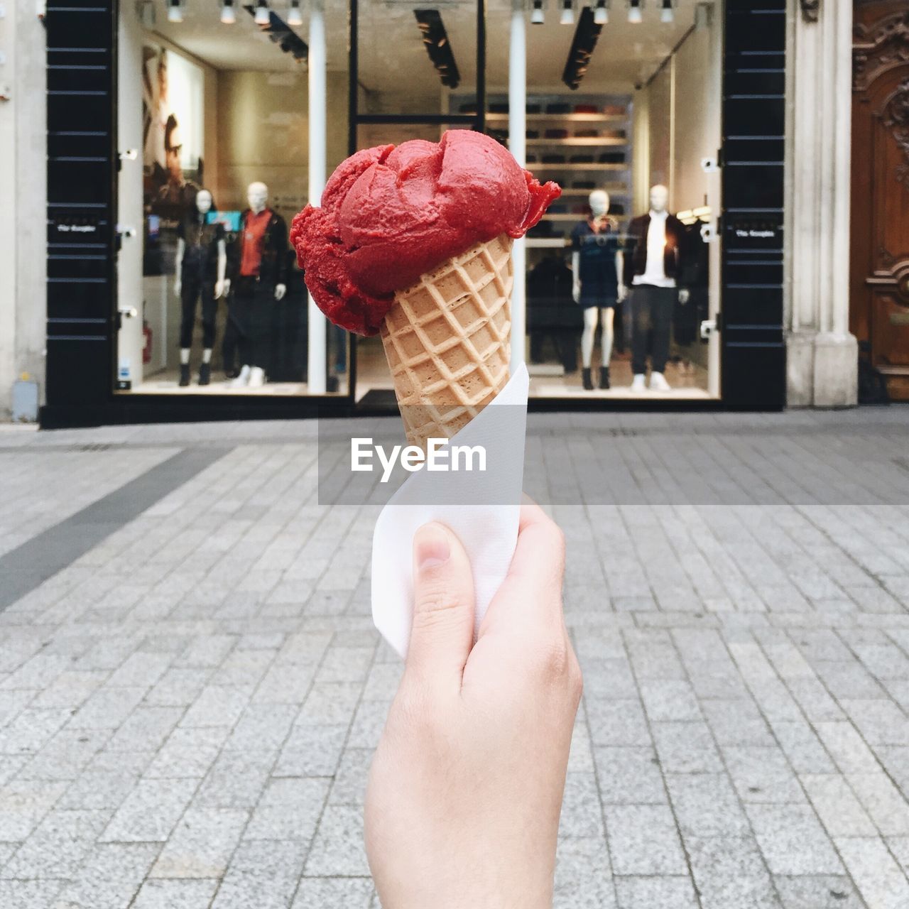 Close-up of hand holding ice cream cone outdoors