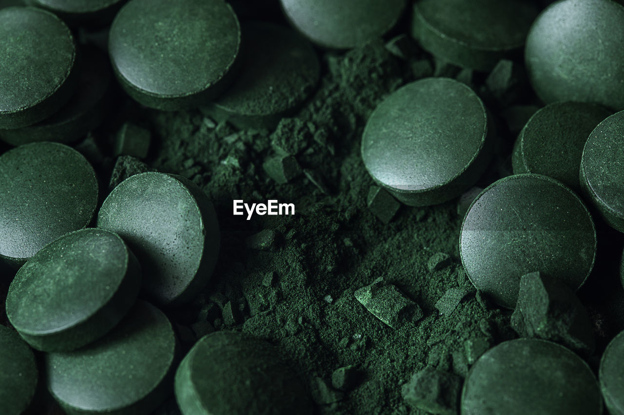 Spirulina powder and tablets algae. macro close up.