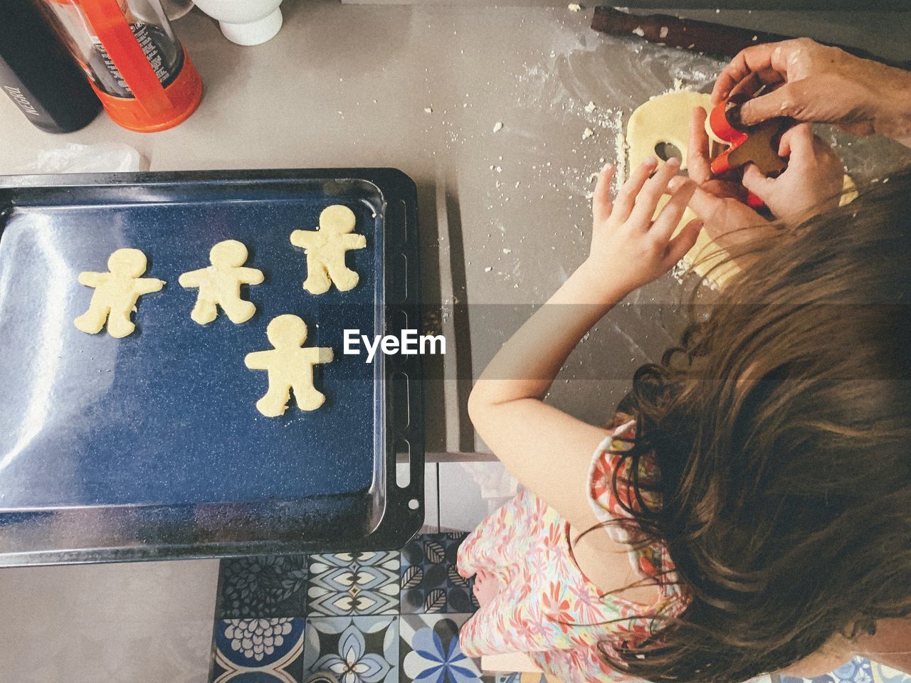 High angle view of little girl baking cookies 