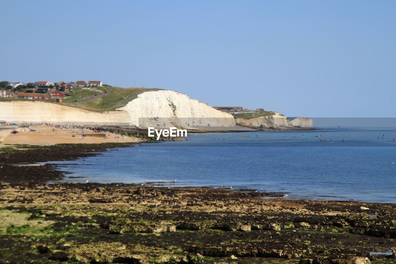 SCENIC VIEW OF SEA AND BAY AGAINST CLEAR SKY