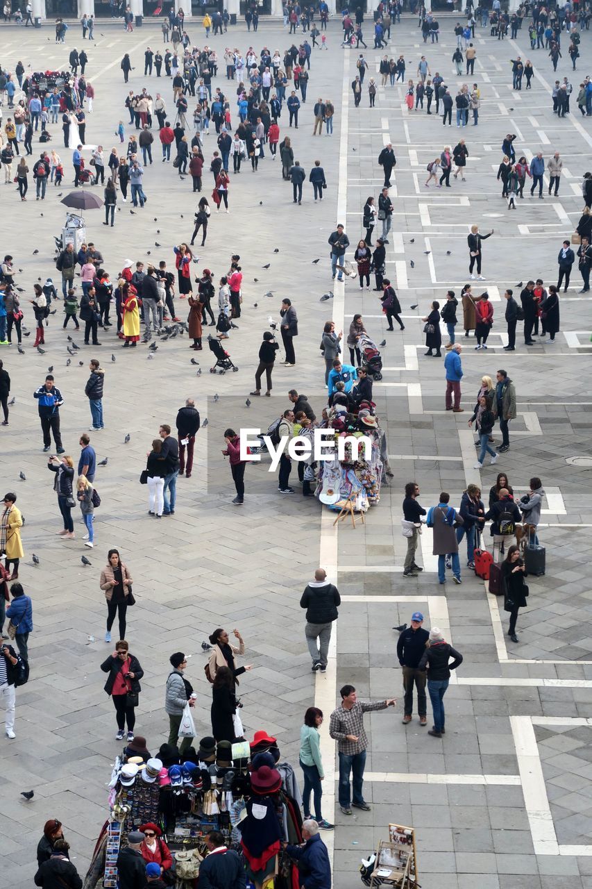 High angle view of people walking on square in city