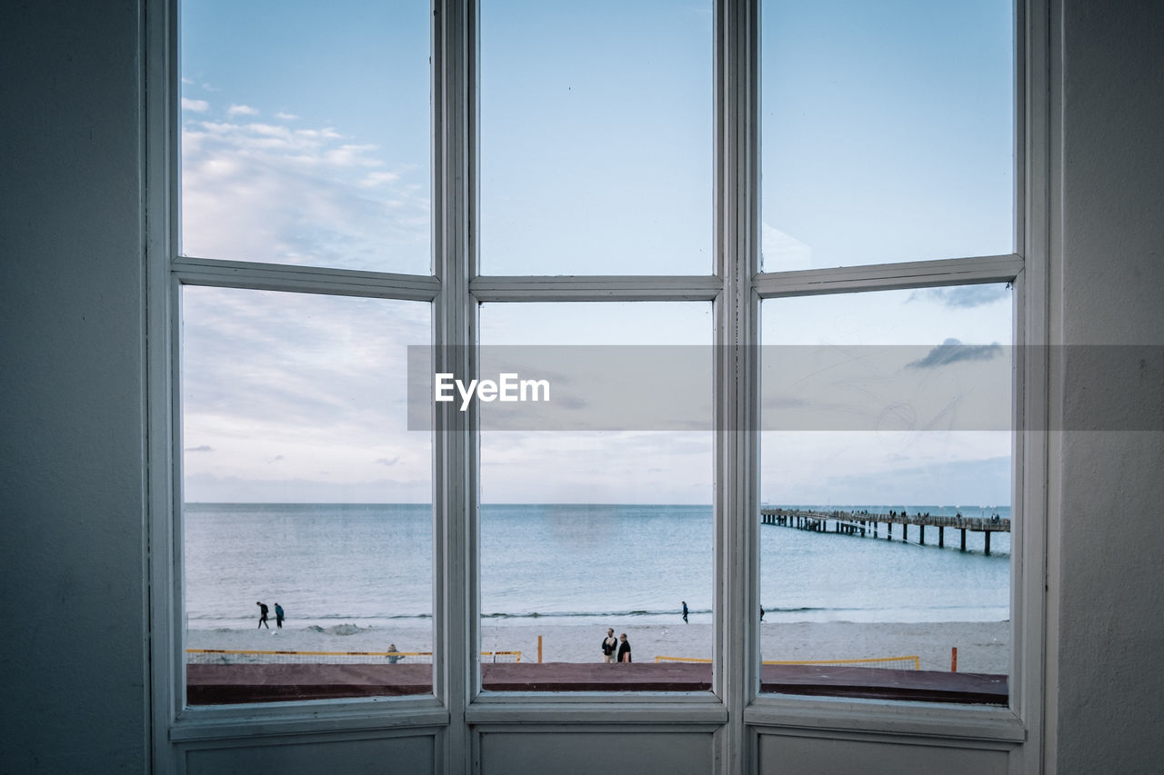 Scenic view of sea seen through glass window