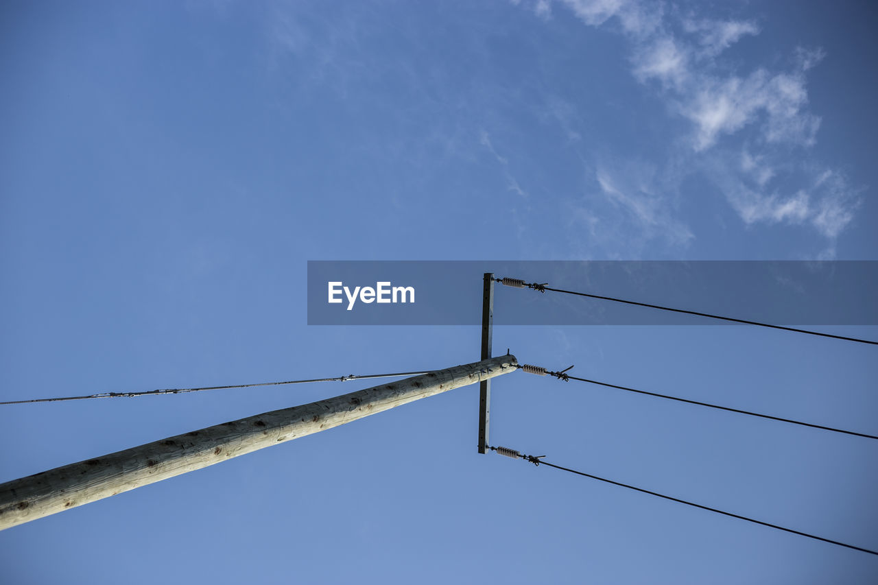 Low angle view of object against blue sky