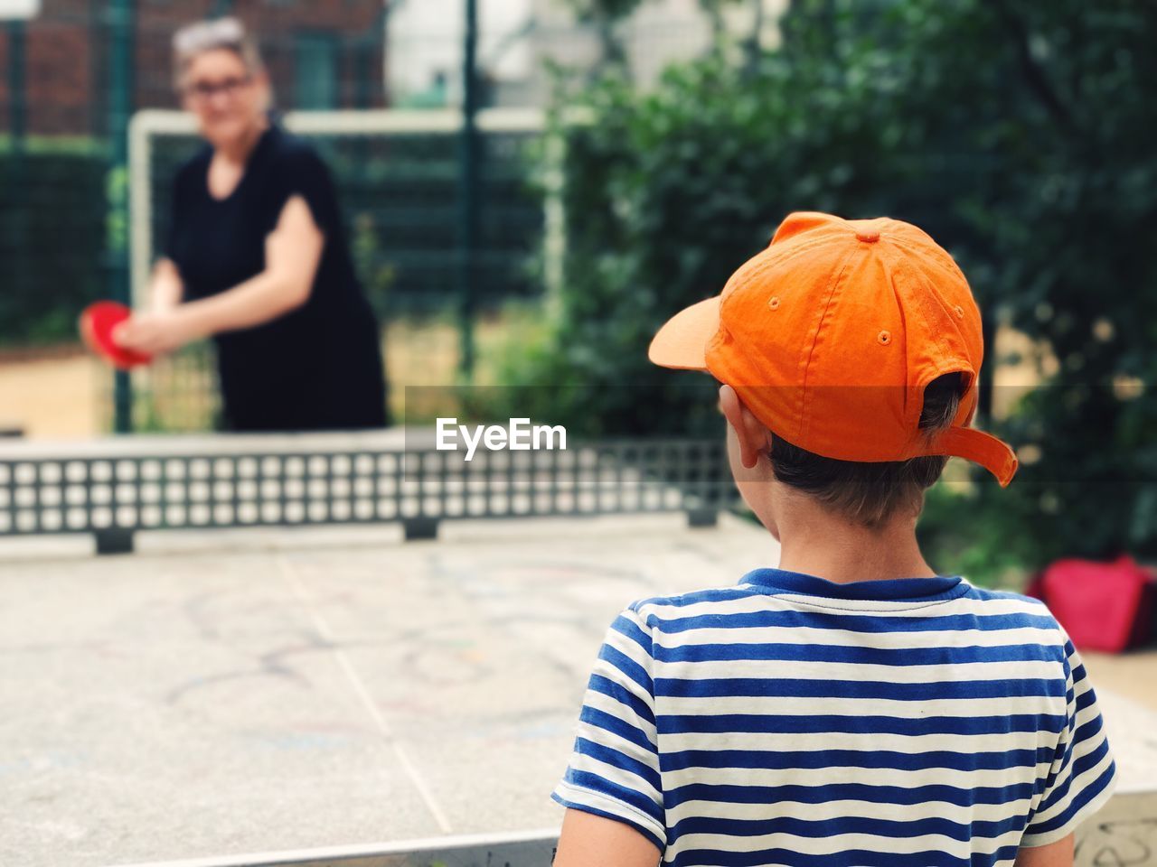 Boy playing table tennis outdoors