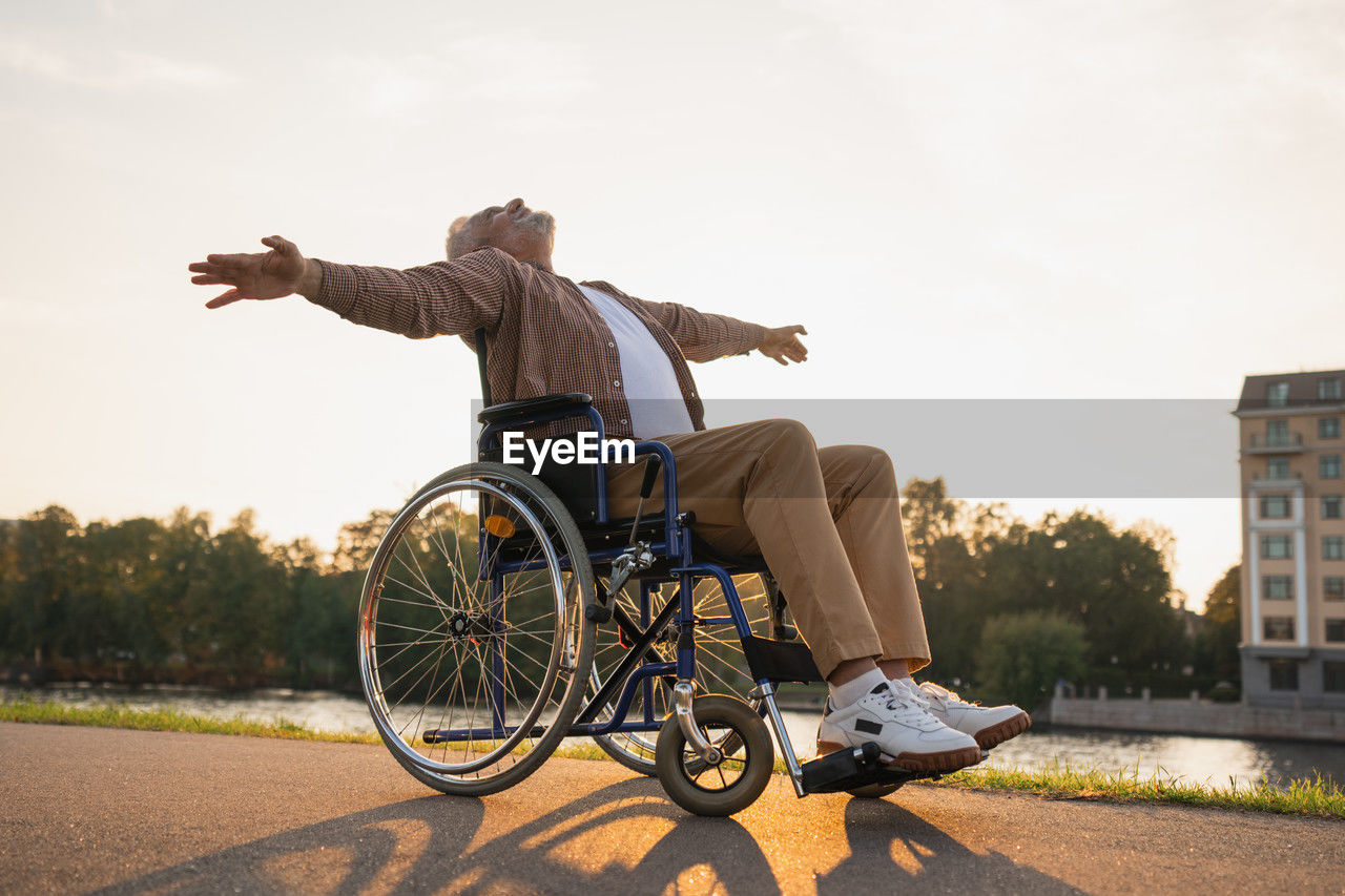 side view of woman riding bicycle on street