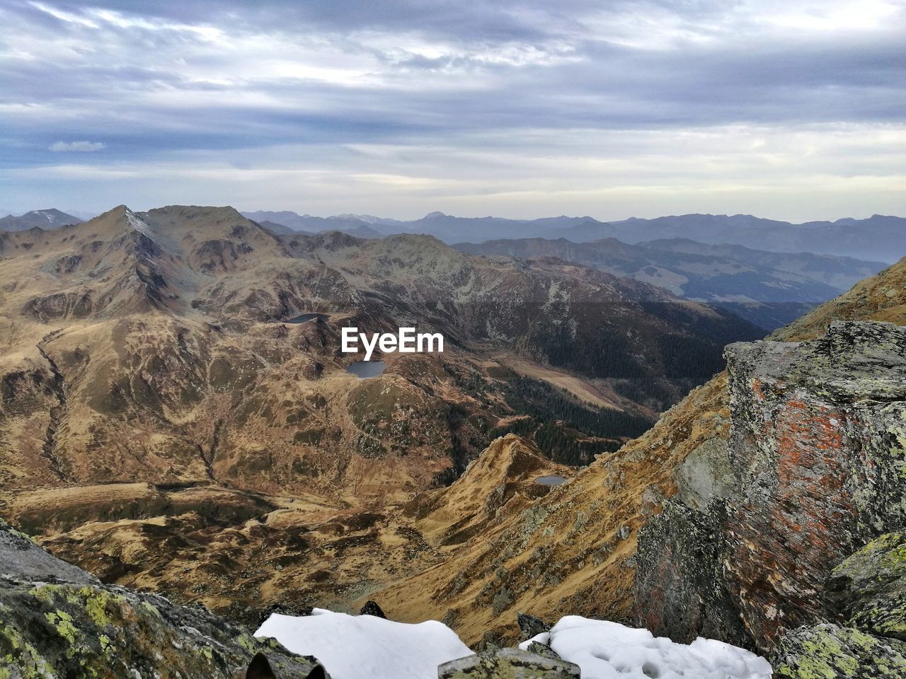 Scenic view of mountains against cloudy sky