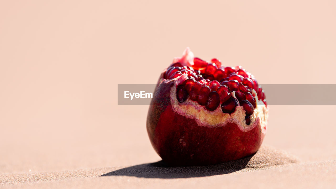 CLOSE-UP OF RED STRAWBERRY ON TABLE