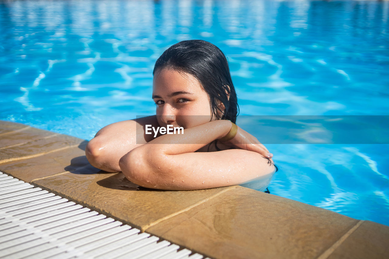 high angle view of young woman swimming in pool