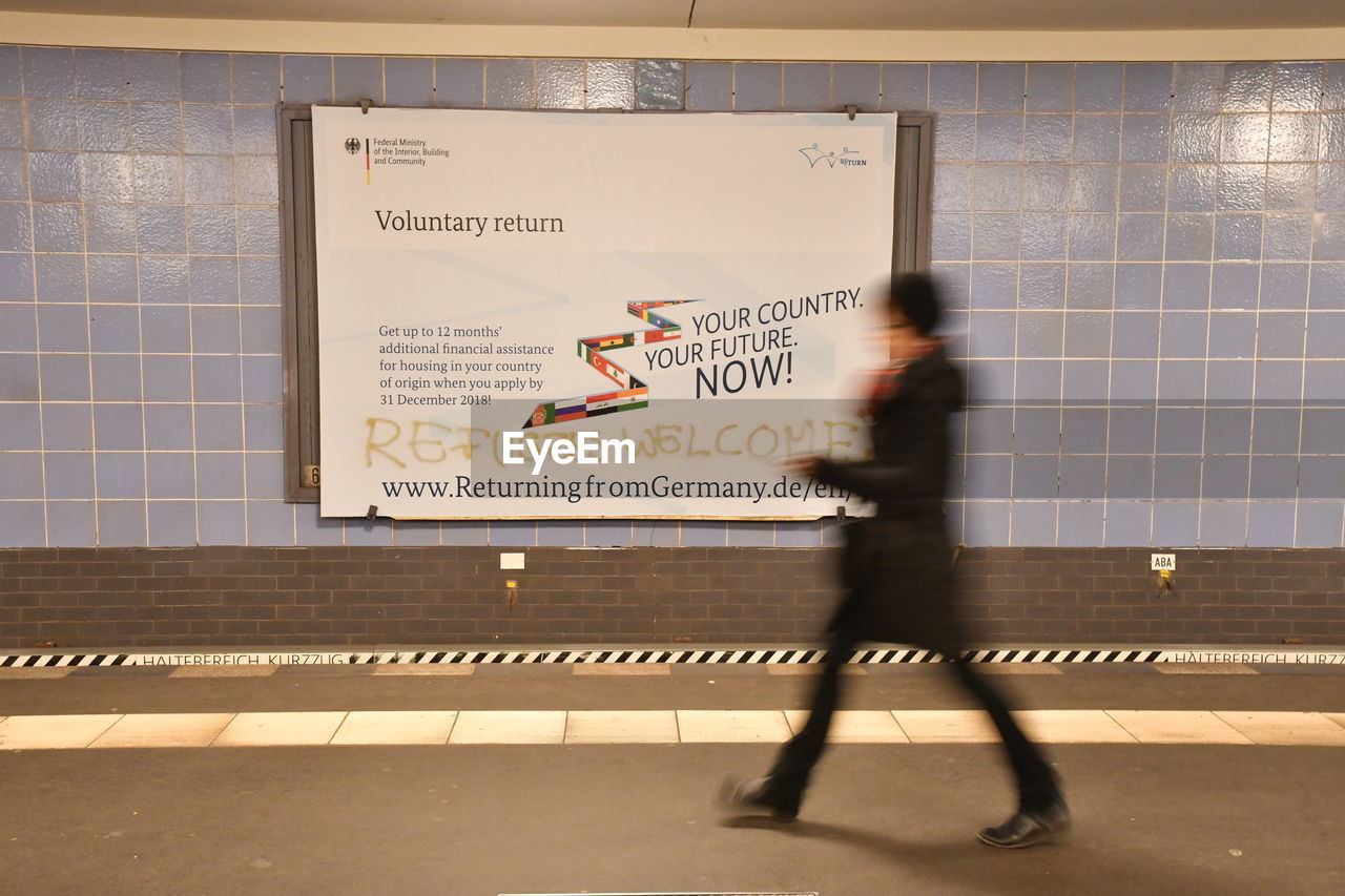 PEOPLE WALKING IN SUBWAY STATION