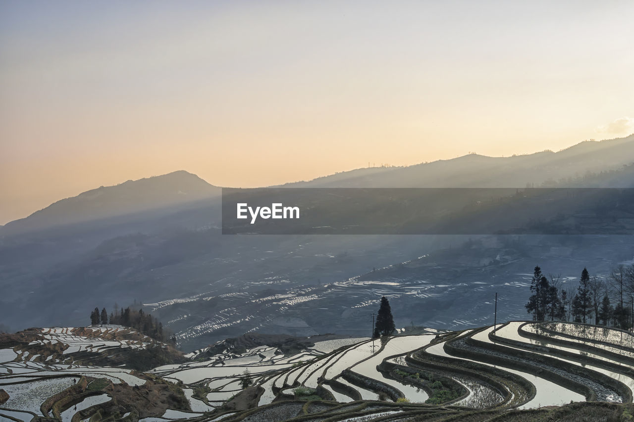 Scenic view of mountains against sky during sunset