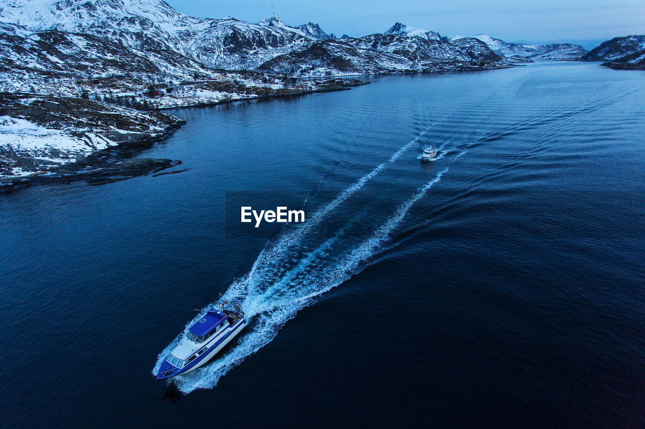 High angle view of boat sailing in lake