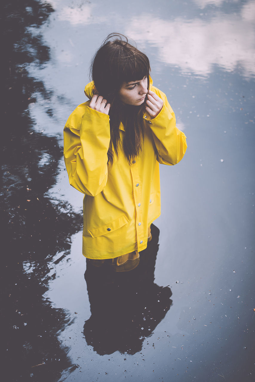 YOUNG WOMAN WITH YELLOW UMBRELLA