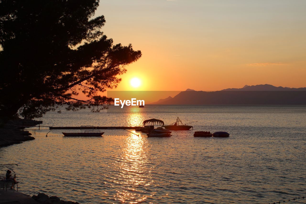 scenic view of sea against orange sky