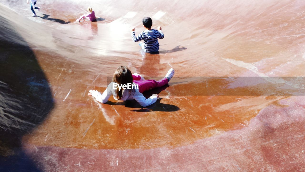 High angle view of children playing on slide