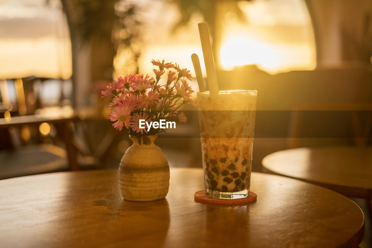 Close-up of glass vase on table in restaurant