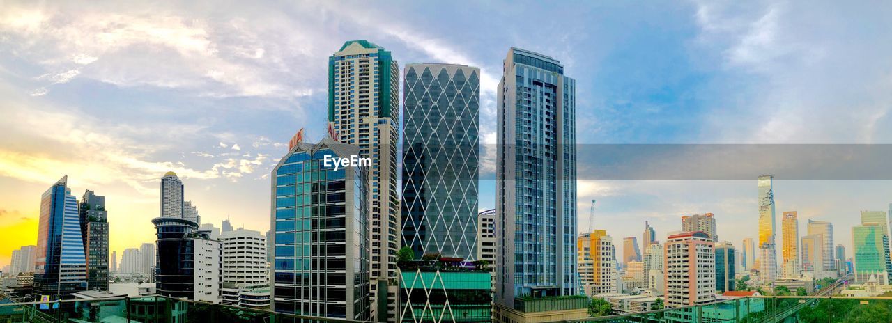 Panoramic view of modern buildings against sky in city