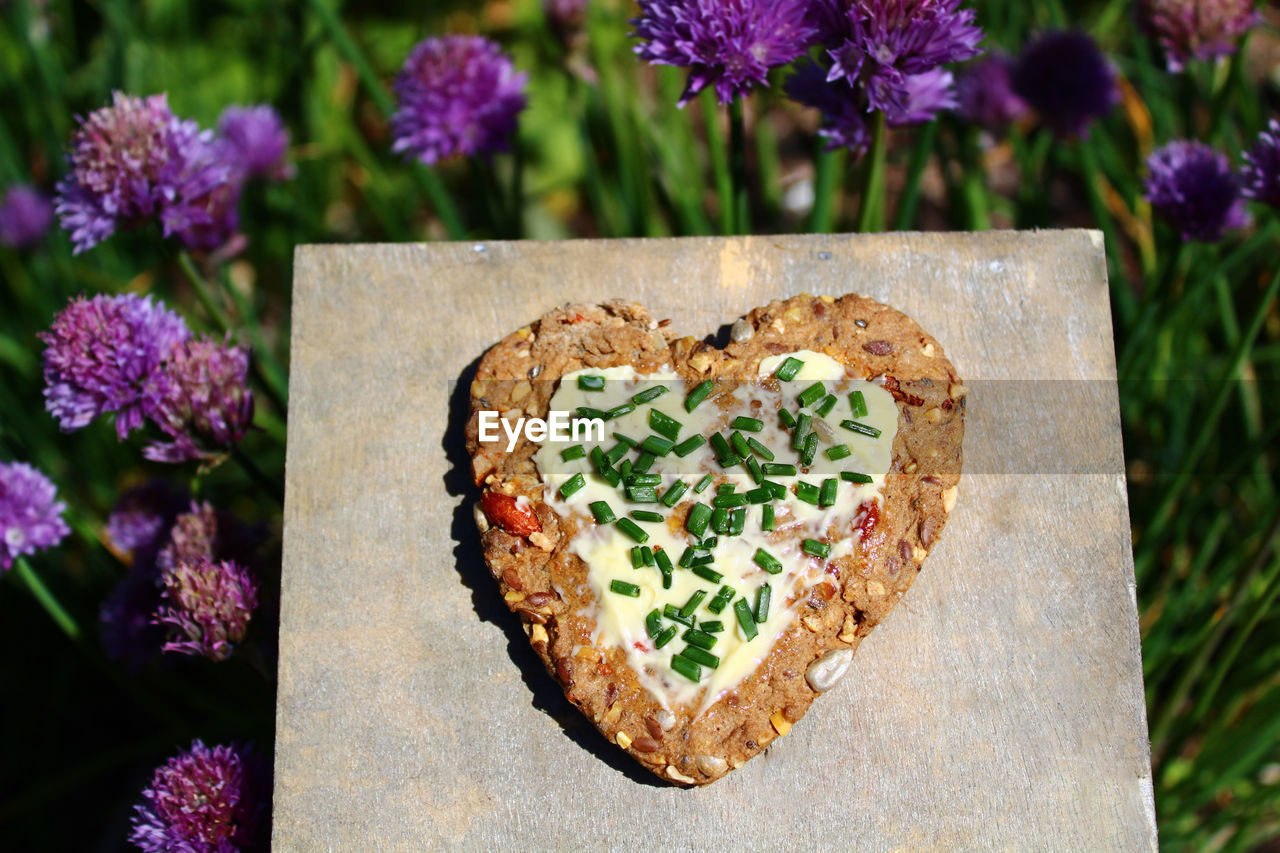 HIGH ANGLE VIEW OF HEART SHAPE MADE ON WHITE ROSE