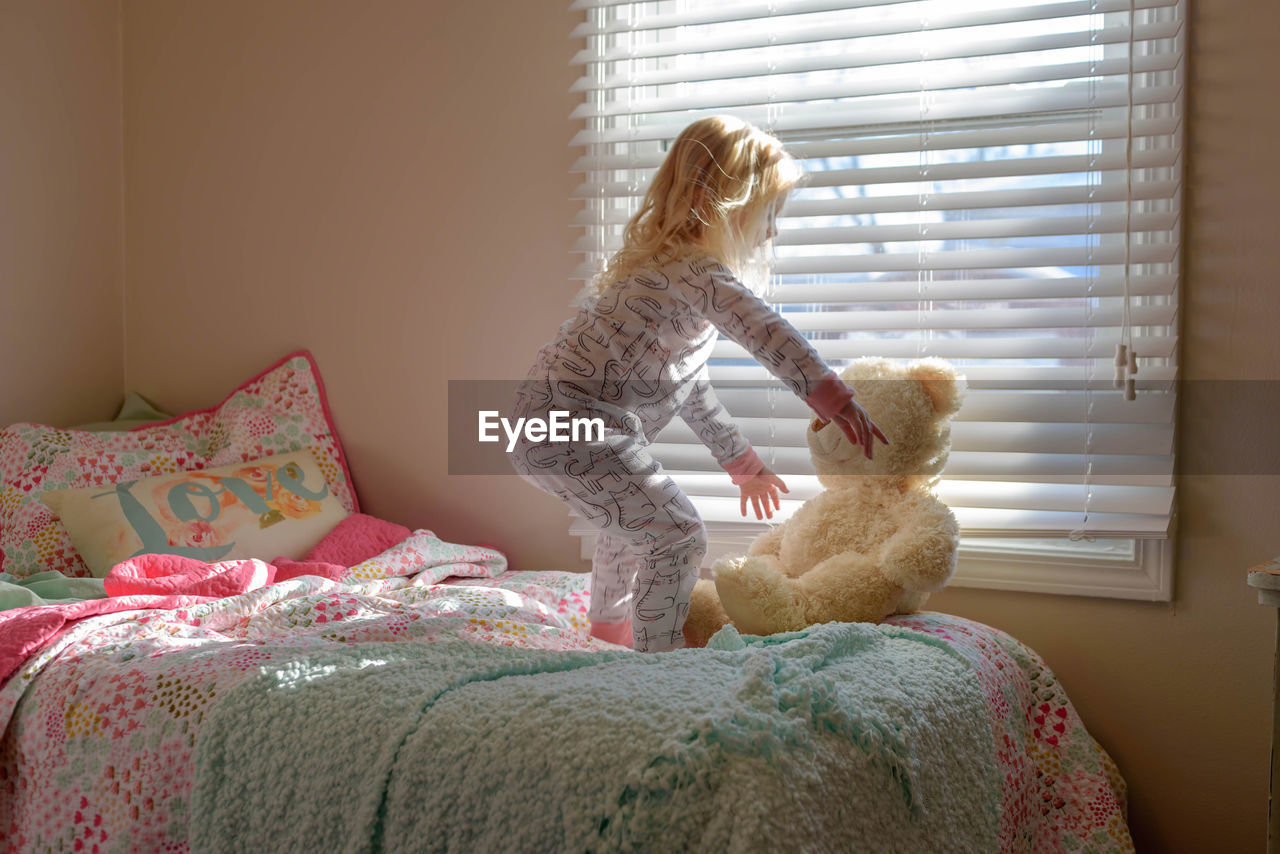 CLOSE-UP OF STUFFED TOY ON BED