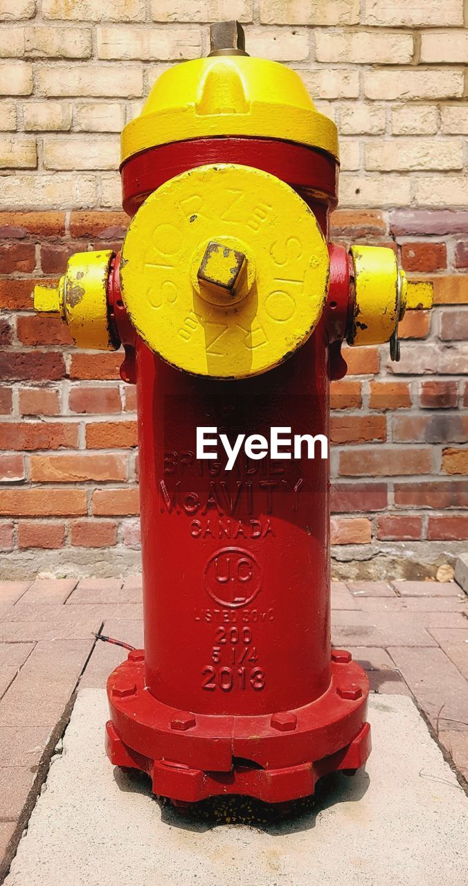 CLOSE-UP OF FIRE HYDRANT ON FOOTPATH