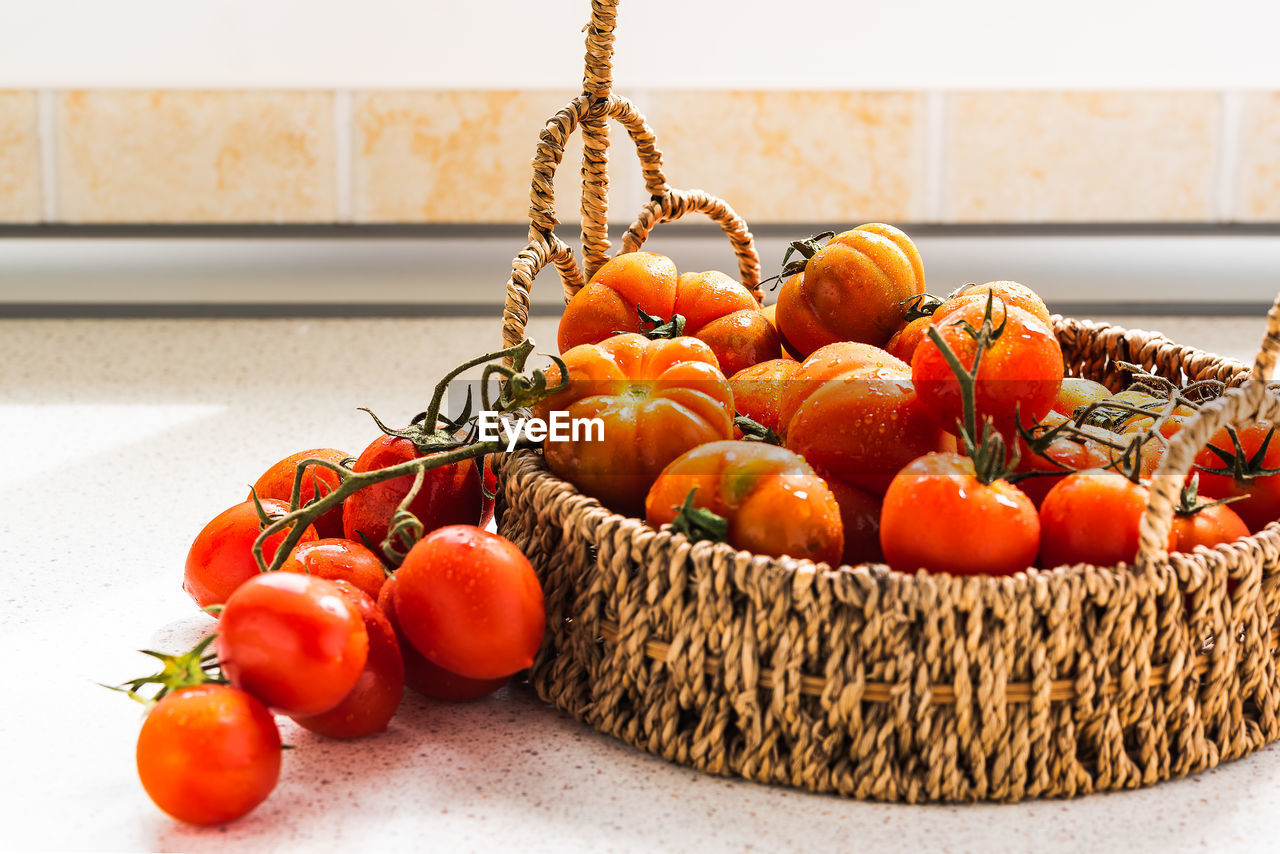 Close-up of tomatoes in basket on table