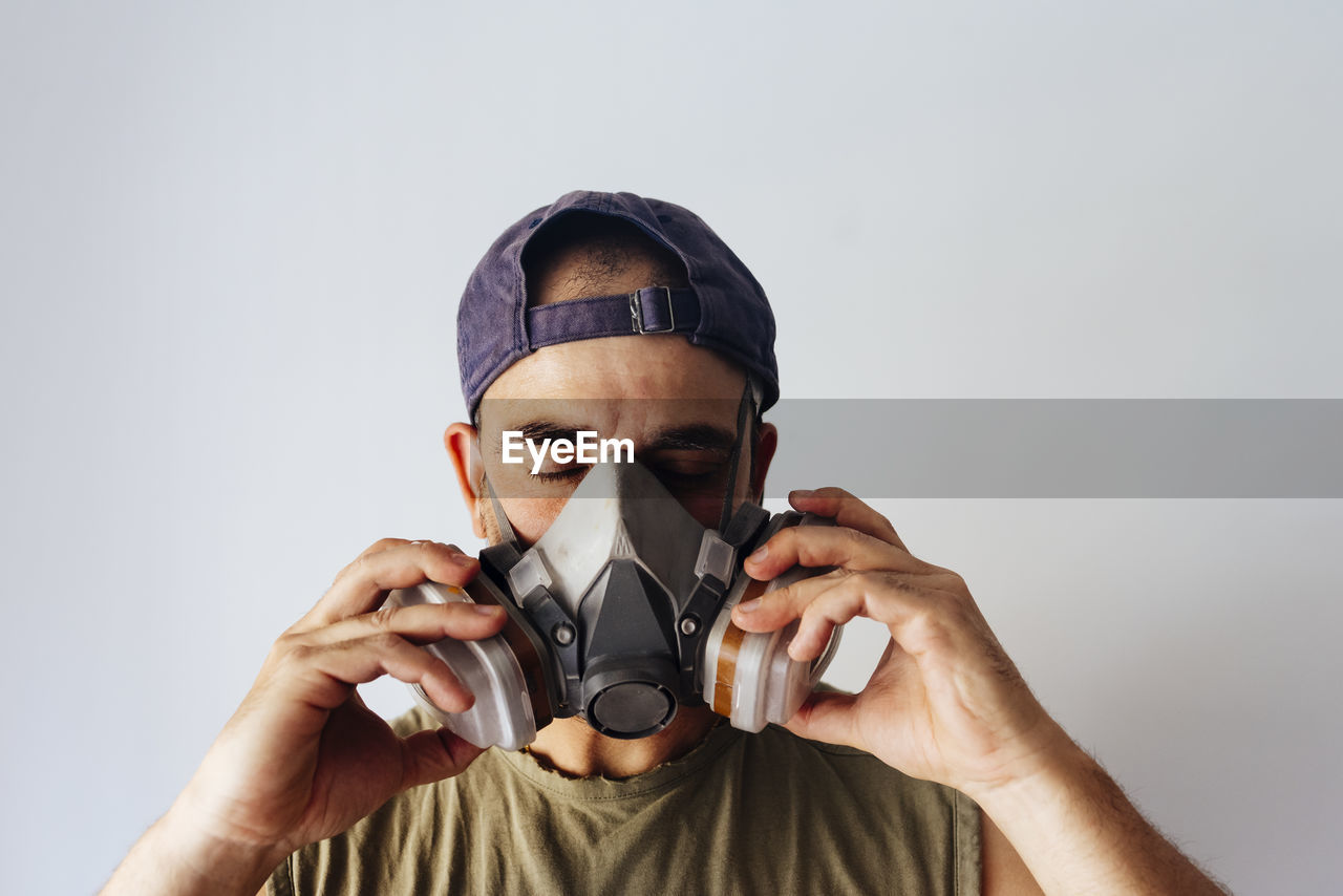 Portrait of airbrush painter putting on his protective mask.