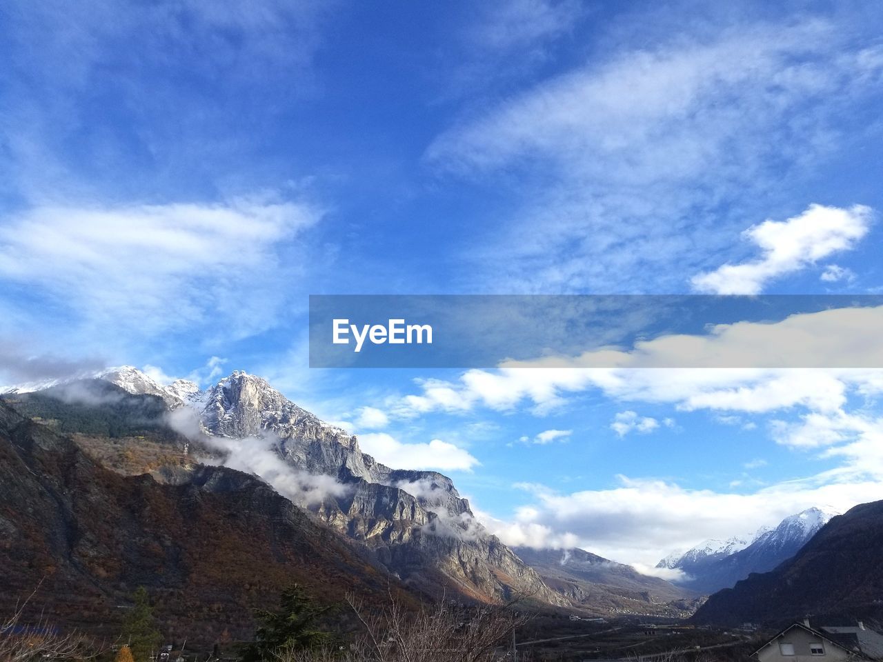 Scenic view of mountains against cloudy sky