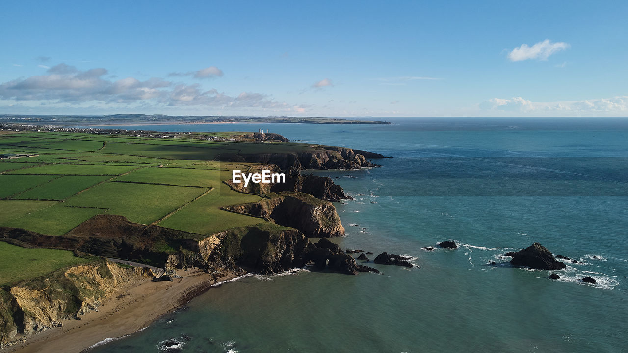 water, sea, land, sky, coast, scenics - nature, beach, landscape, environment, ocean, nature, beauty in nature, body of water, shore, horizon, coastline, terrain, bay, travel, cloud, cliff, travel destinations, horizon over water, cove, tranquility, blue, outdoors, tranquil scene, tourism, no people, islet, rock, day, architecture, island, idyllic, rural scene, trip, vacation, seascape, holiday, aerial view, non-urban scene, building, transportation, bay of water, summer, high angle view, sports