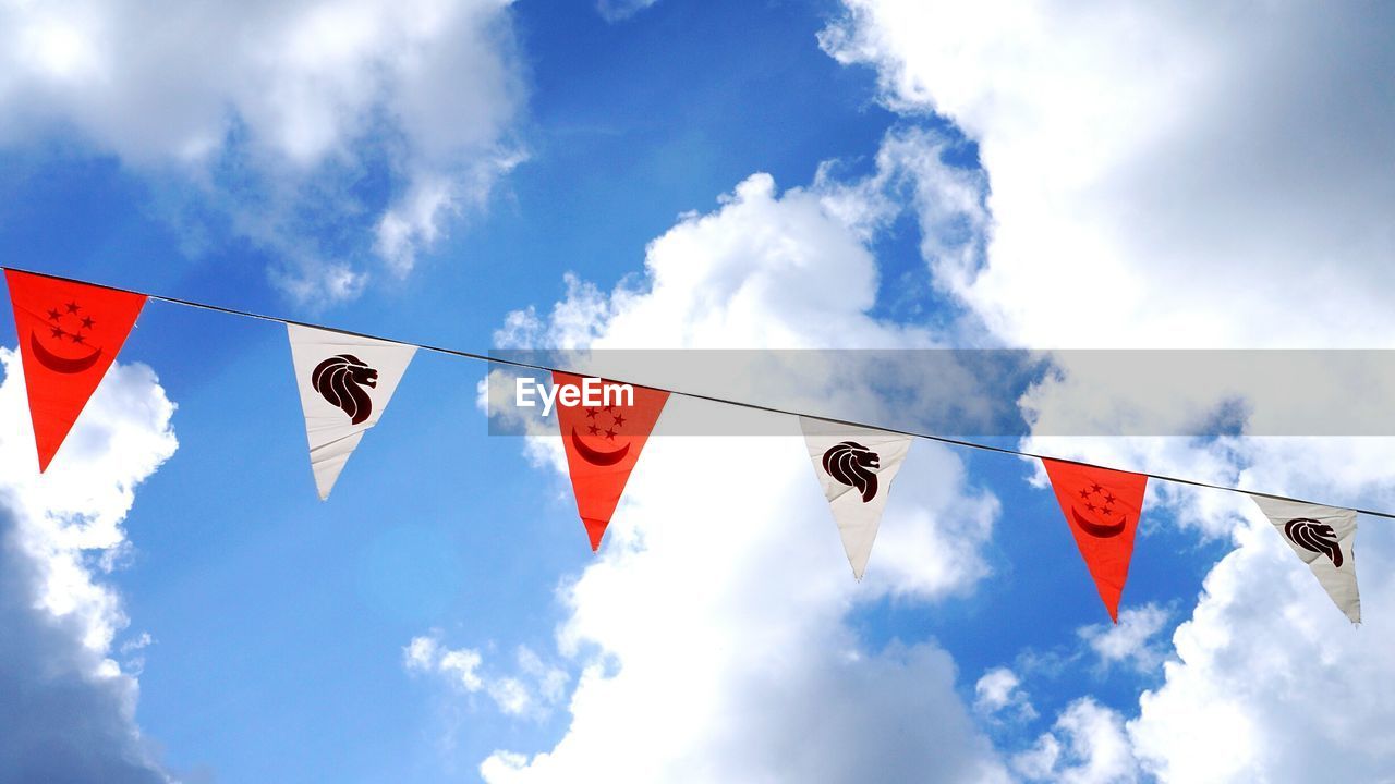 LOW ANGLE VIEW OF FLAGS FLAG AGAINST SKY