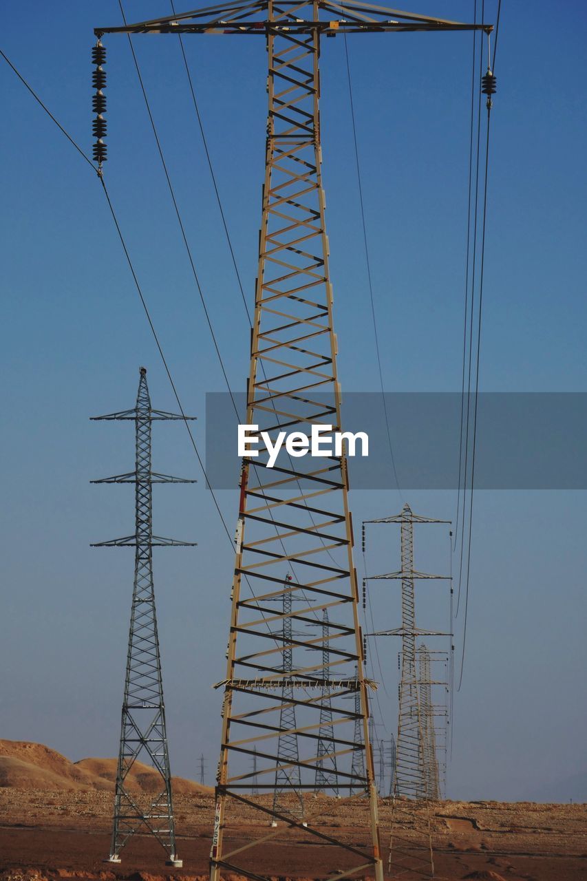 Low angle view of electricity pylon in desert 
