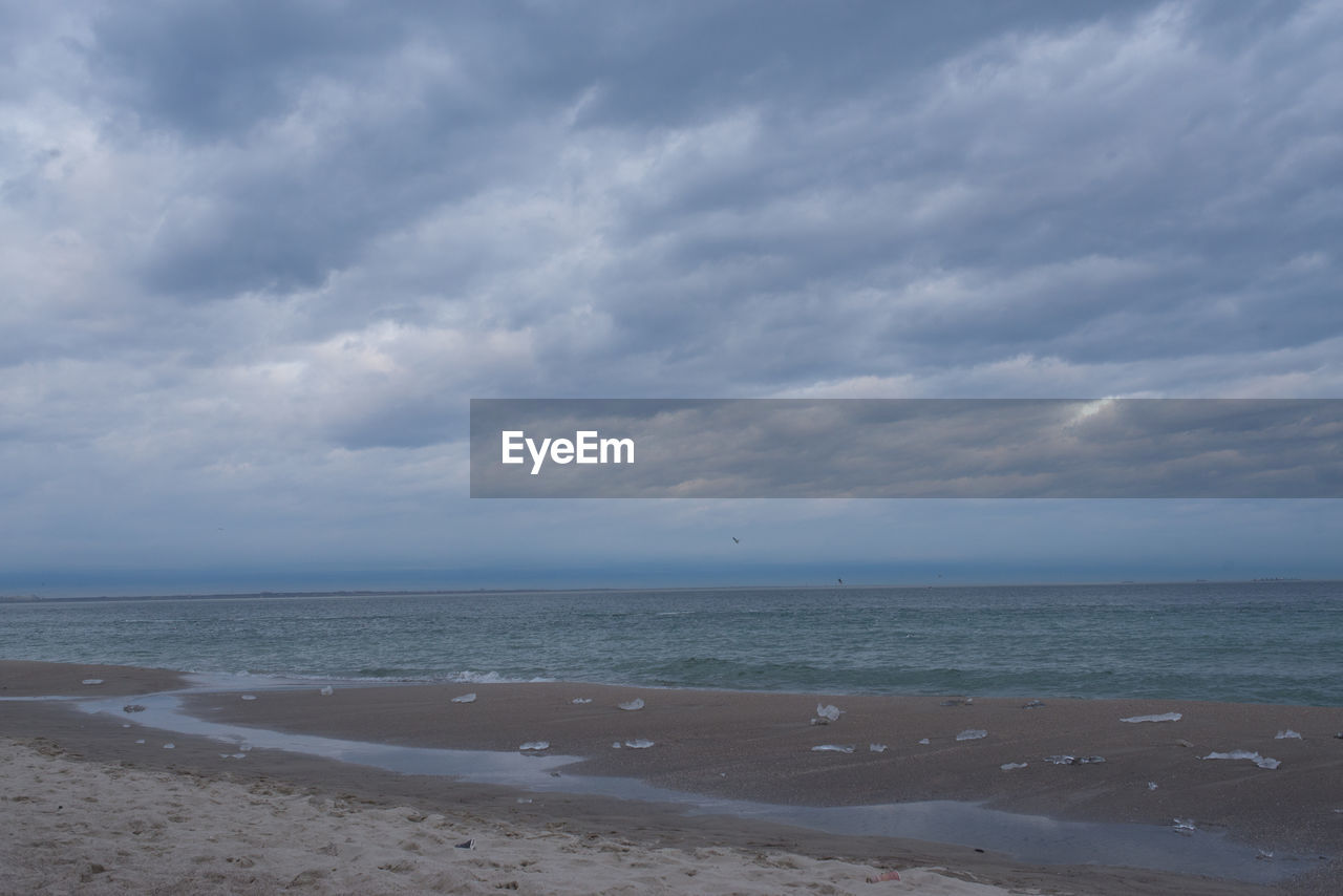 VIEW OF SEA AGAINST CLOUDY SKY