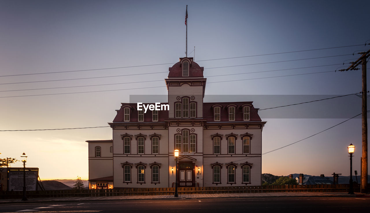 BUILDING AGAINST SKY AT SUNSET