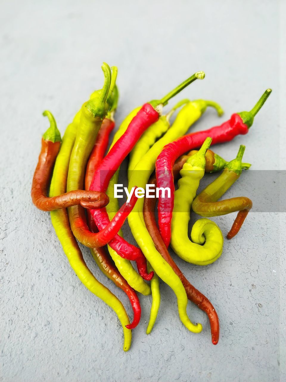 CLOSE-UP OF RED CHILI PEPPERS ON TABLE