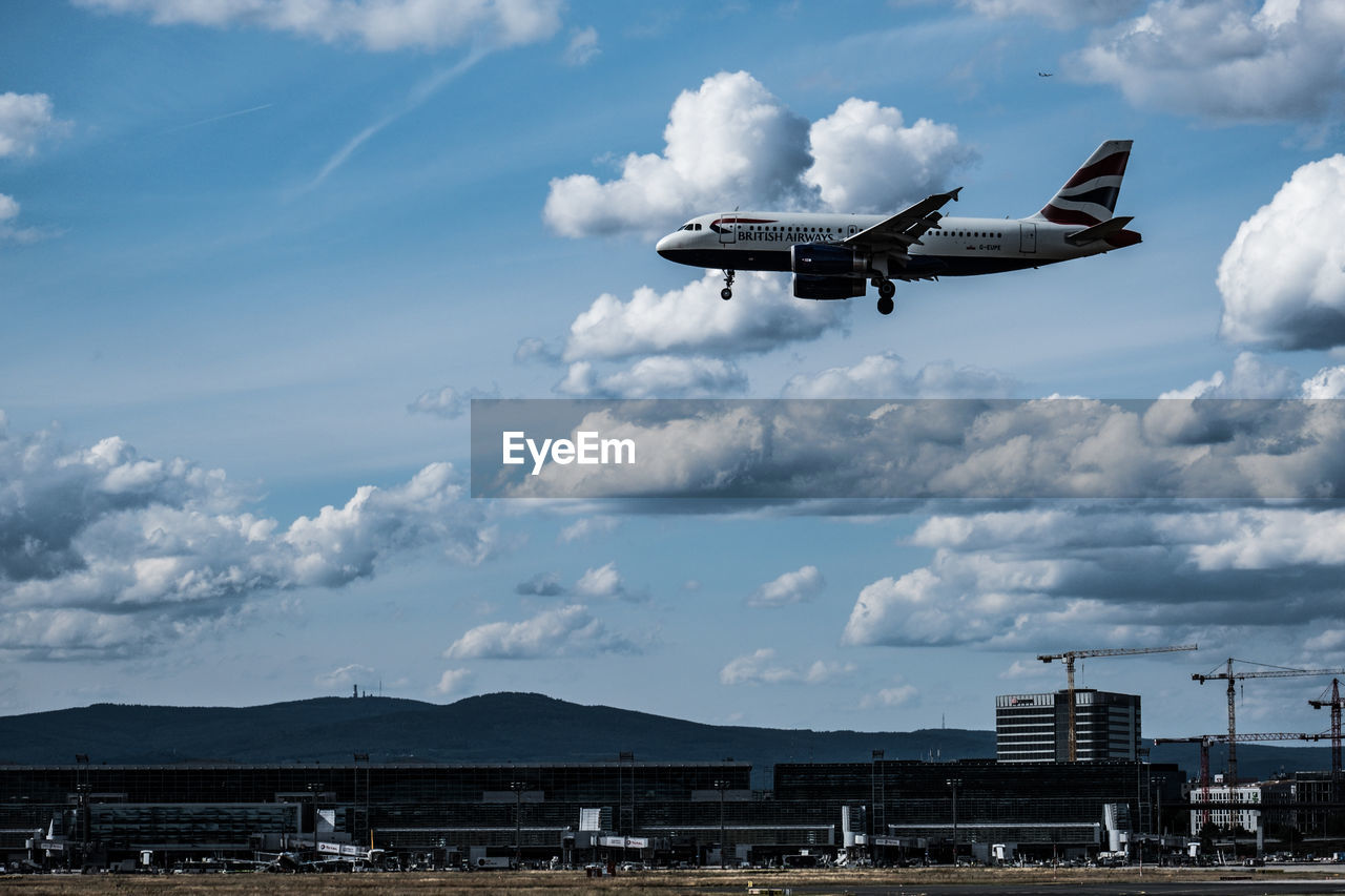 LOW ANGLE VIEW OF AIRPLANE FLYING OVER WATER AGAINST SKY