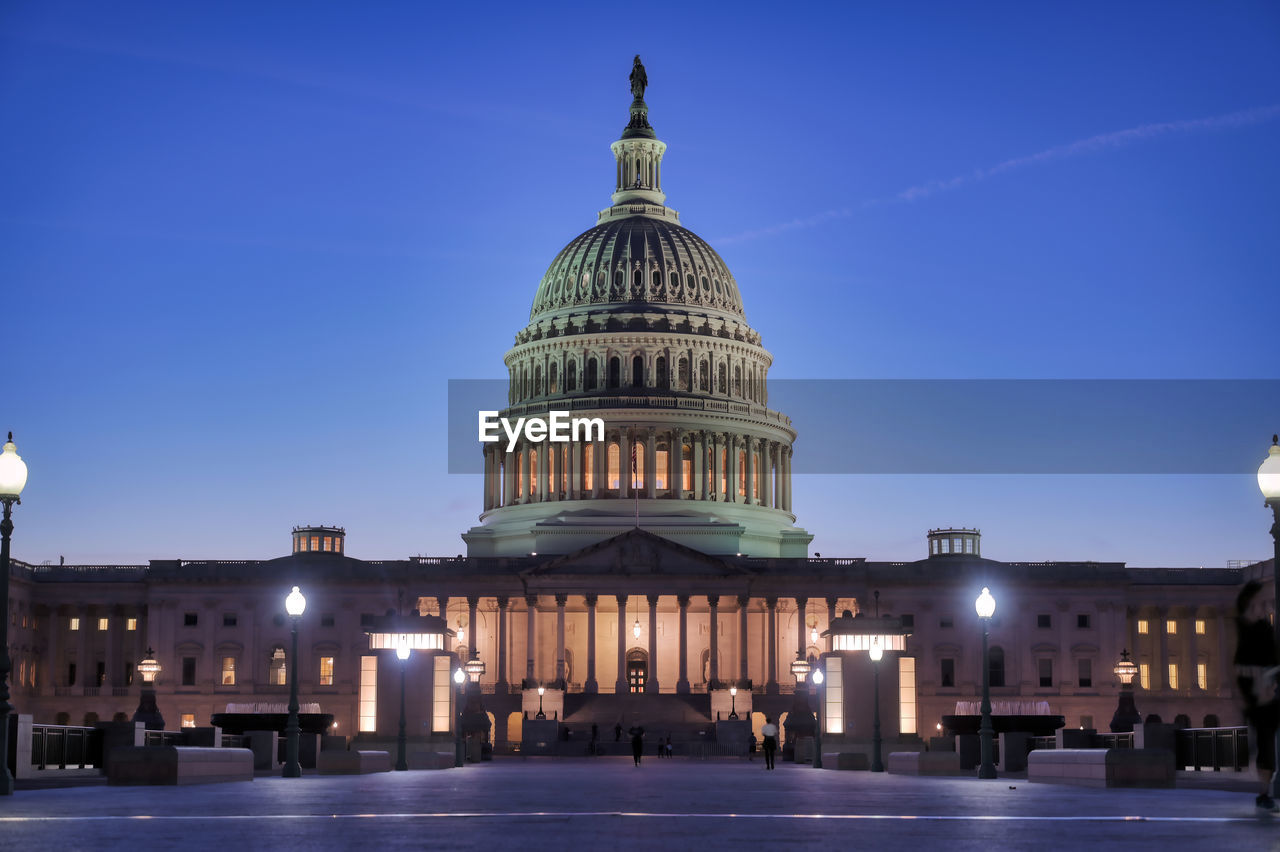 Illuminated building against clear sky at dusk