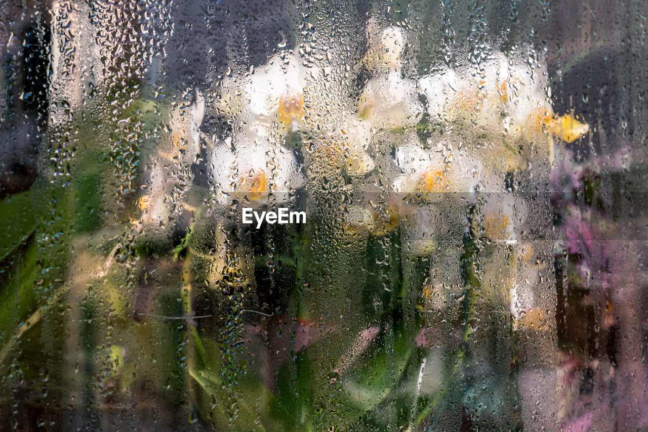Full frame shot of raindrops on glass window