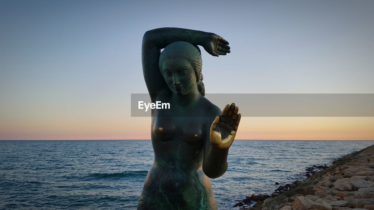 STATUE OF WOMAN IN WATER