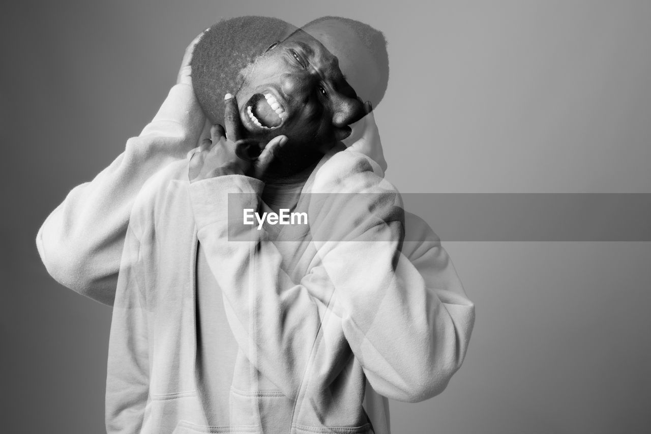 Portrait of person standing against white background